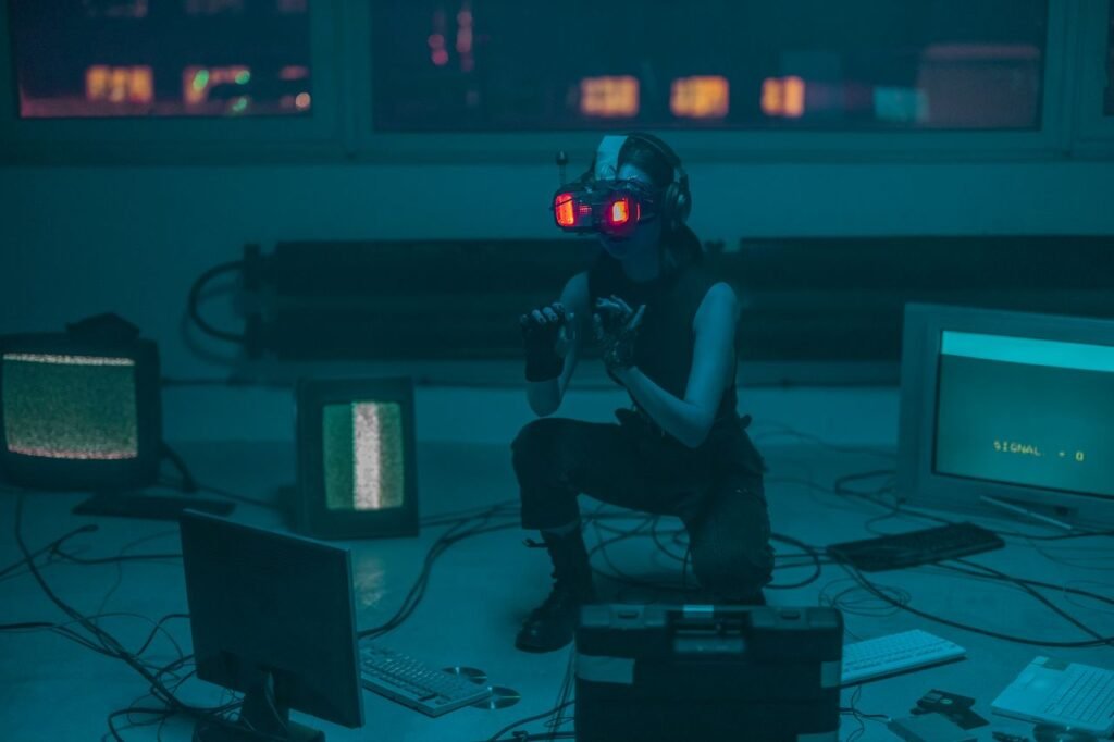 A woman crouching with VR headset in a sci-fi room filled with digital screens.